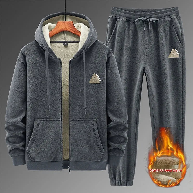 Grey hooded sweater and matching cotton trousers casual sport suit laid flat