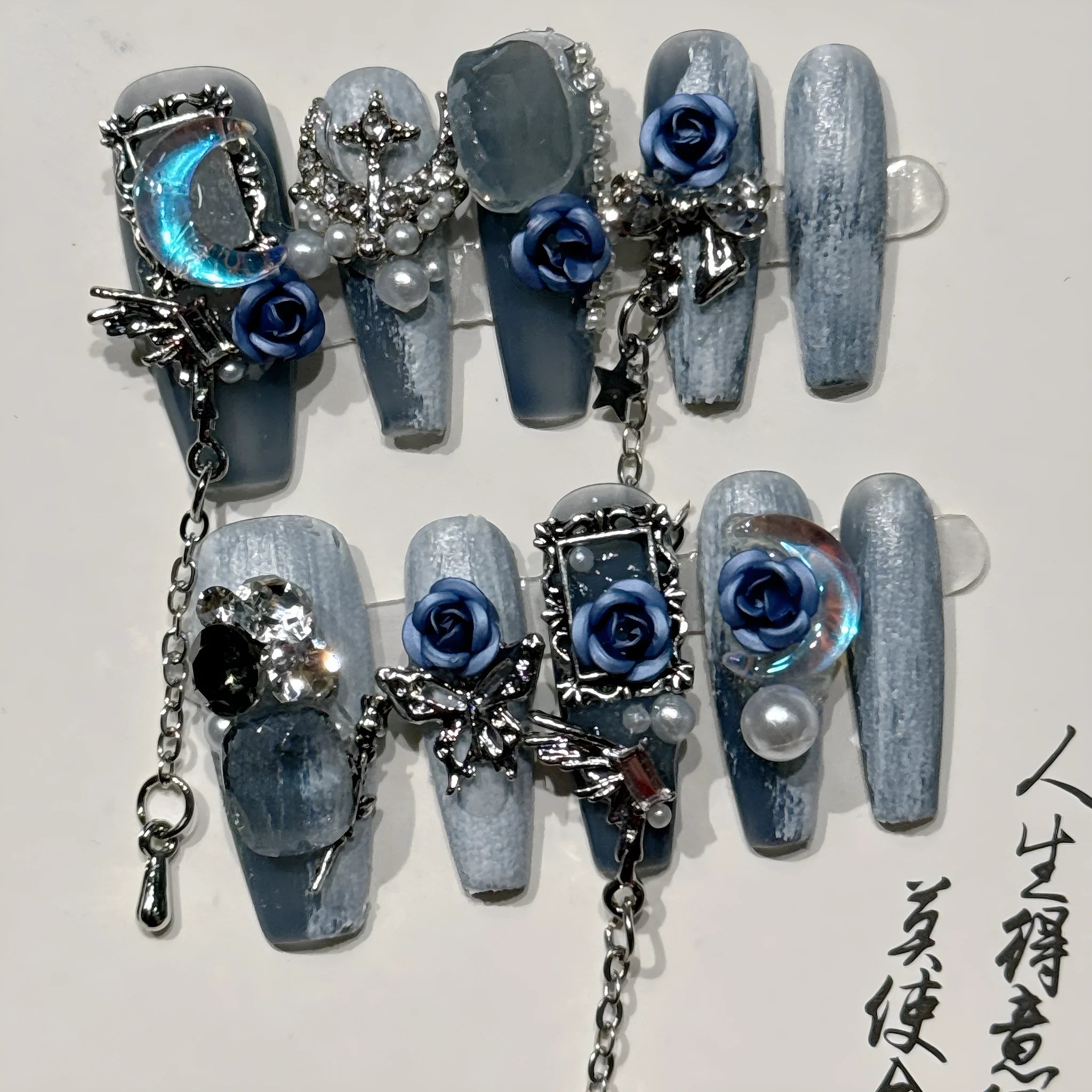Blue false nails with rose and flower pattern, shown in a set with sizes XS, S, M, L.