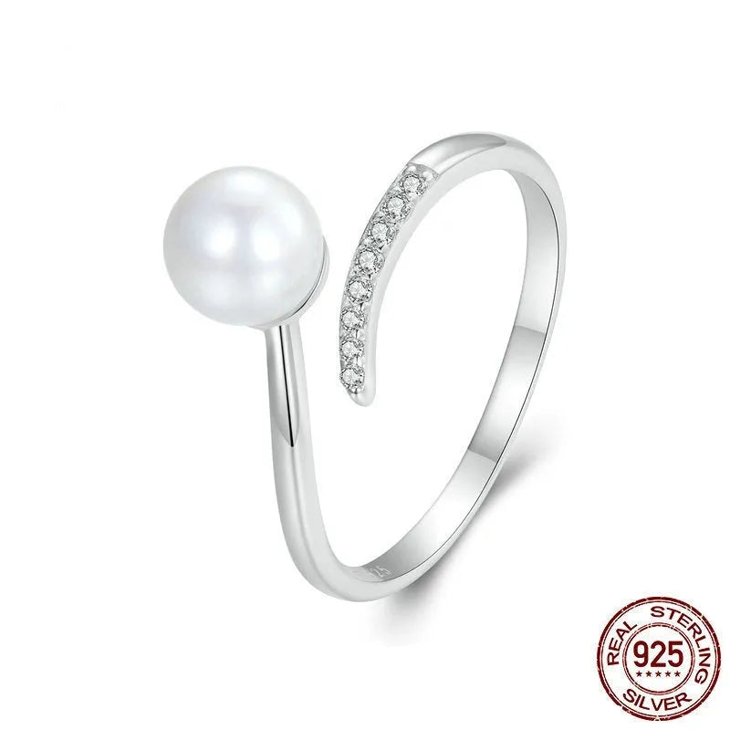 S925 sterling silver adjustable open loop ring with a natural shell pearl on a white background.