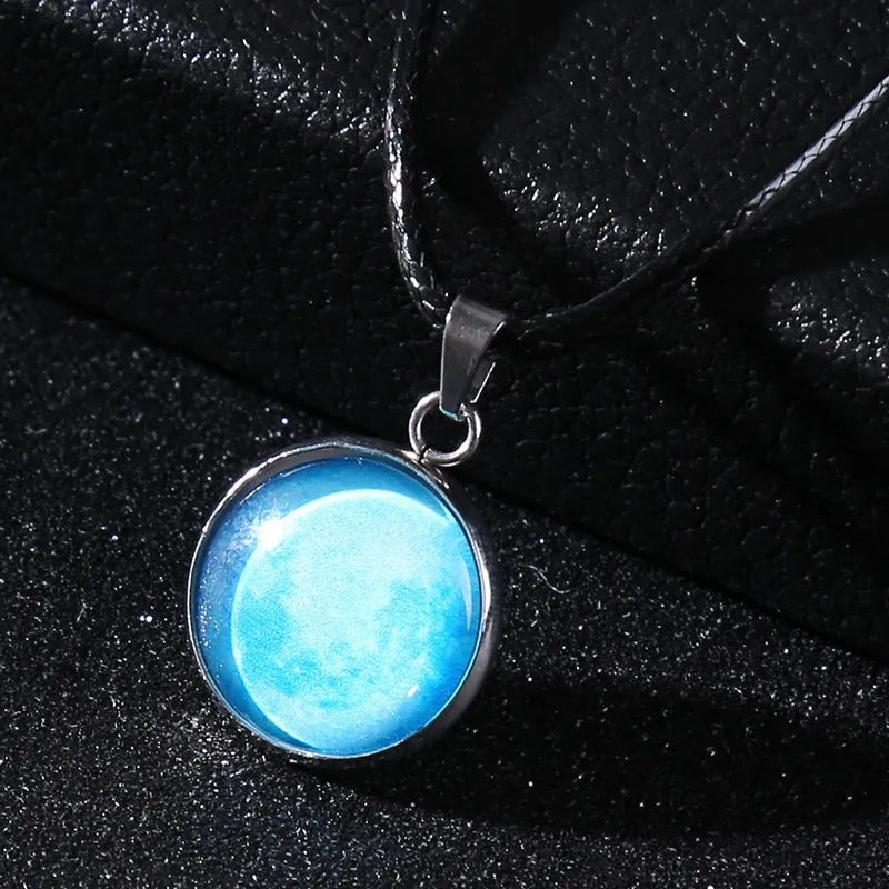 Luminous moon and constellation glass pendant on a silver alloy necklace chain with an extension piece.