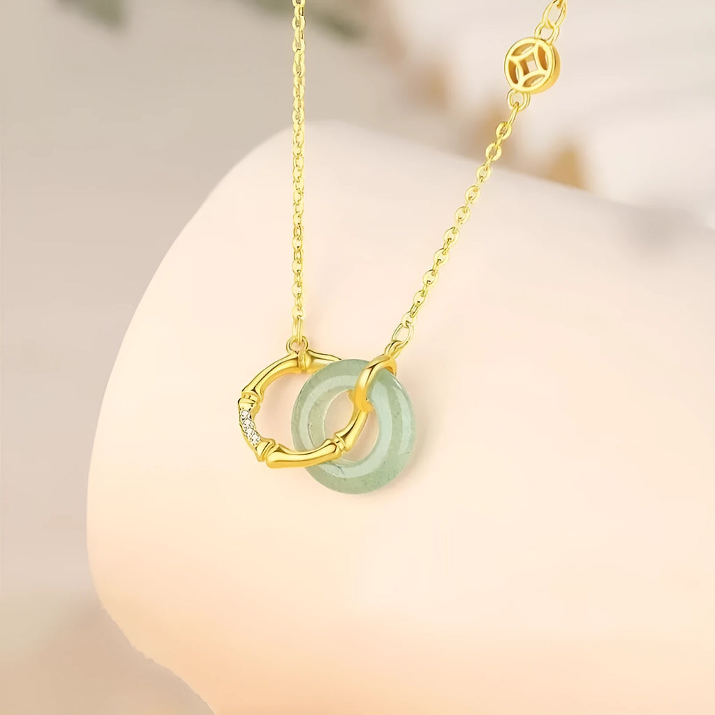 Sterling silver bamboo joint peace buckle necklace on an adjustable O-ring chain with a geometric pearl detail.