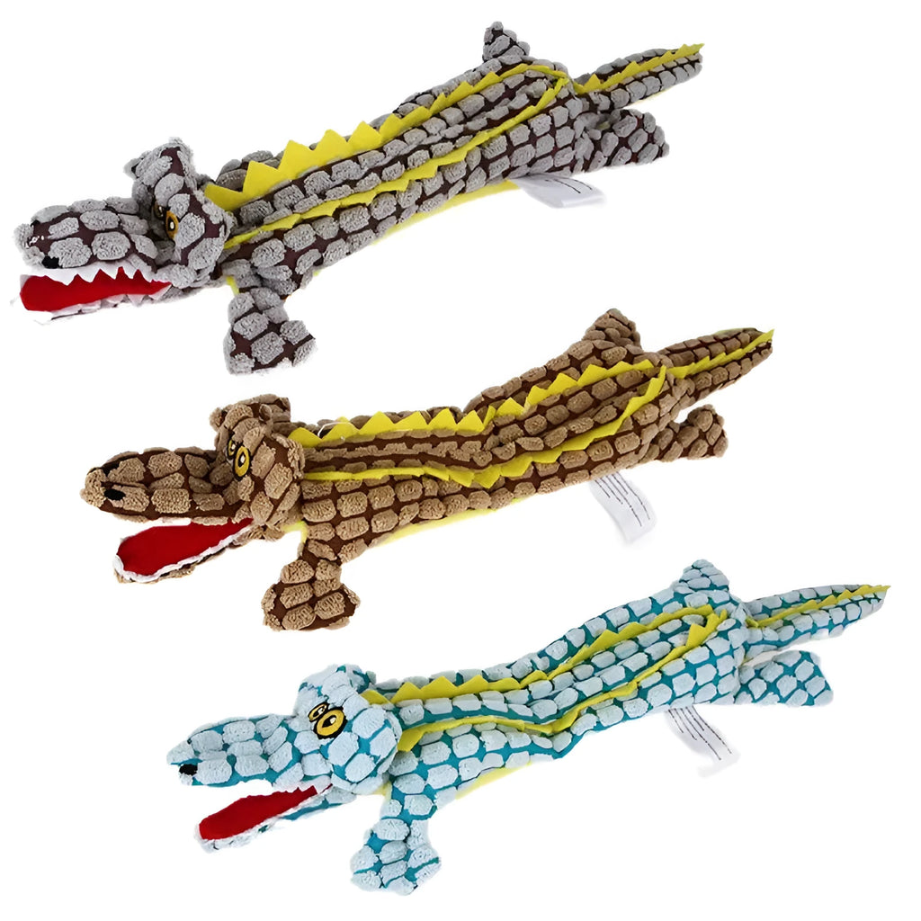 Blue plush crocodile-shaped dog toy with corduroy texture and squeaker, shown next to measuring tape