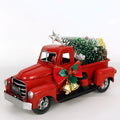 Retro red wrought iron Christmas truck ornament on a white surface, side view showing 17 cm length