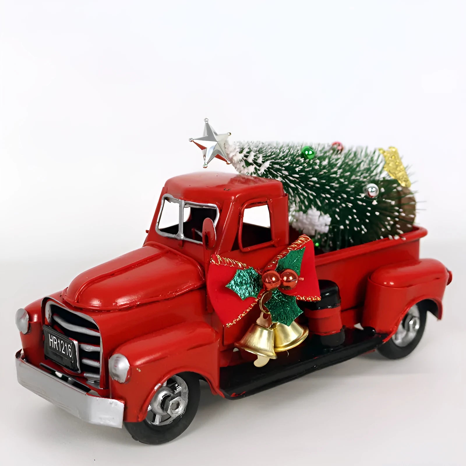 Retro red wrought iron Christmas truck ornament on a white surface, side view showing 17 cm length