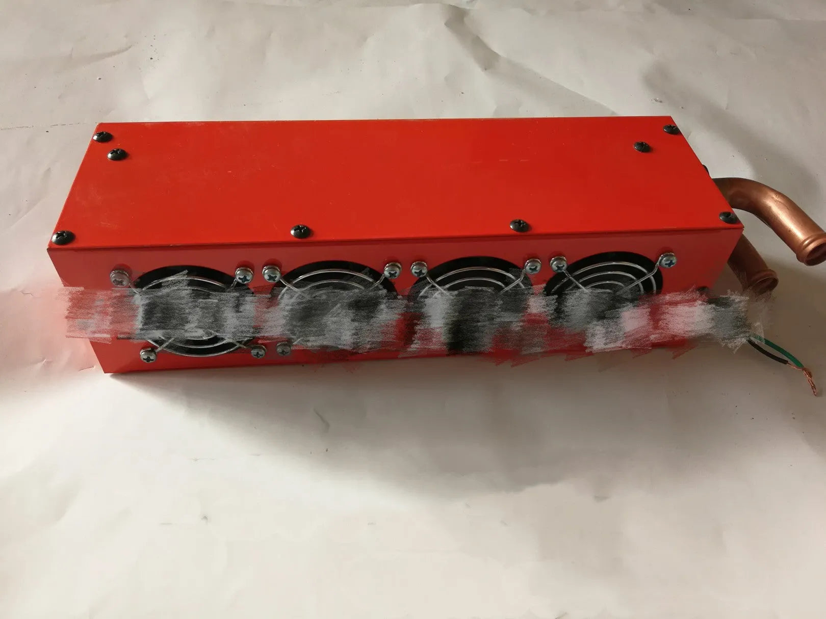 Small four-hole copper pipe car heater with metal housing and manual controls
