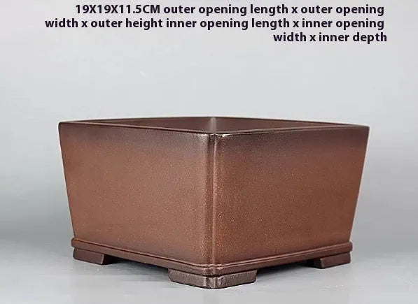 Brown handmade antique purple clay flower pot with classical design.
