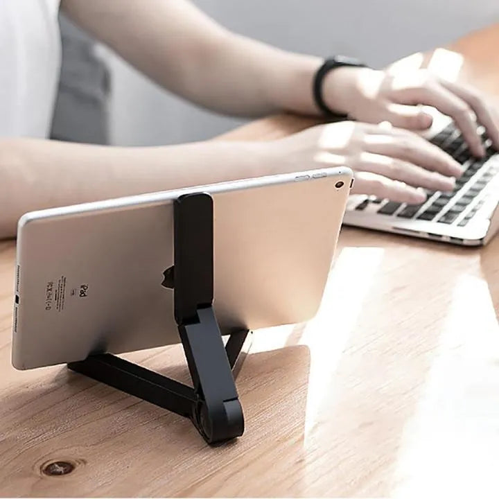 Black foldable tablet holder standing upright holding a tablet, shown next to its folded flat profile.