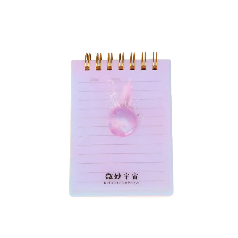 Set of four A7 spiral-bound pocket notebooks with rollover coils, showing Constellation, Sakura, Ocean, and Universe cover designs.
