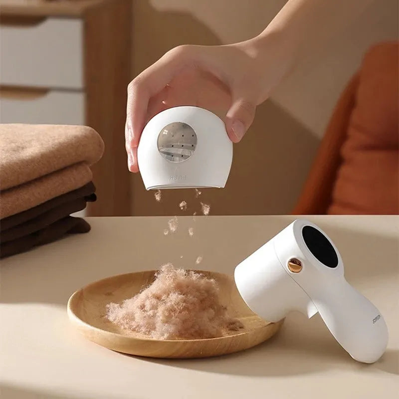 White electric lint remover with LED display showing fabric shaver dimensions