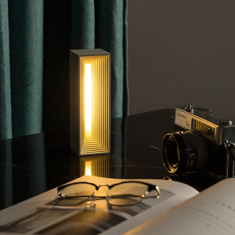 Concrete building night light table lamp in cement grey with LED illumination and Nordic style
