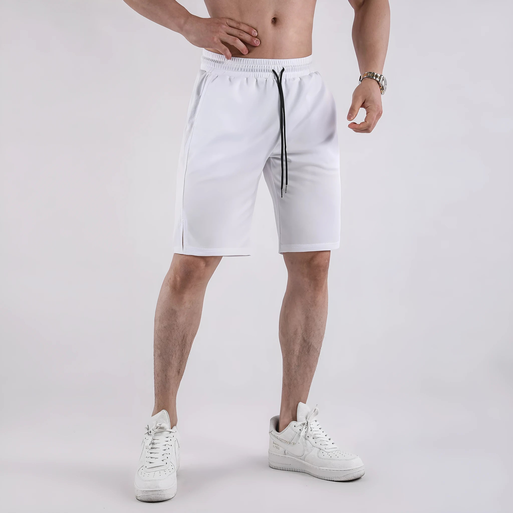 Man wearing loose black quick-dry polyester fitness shorts with an elastic waistband.