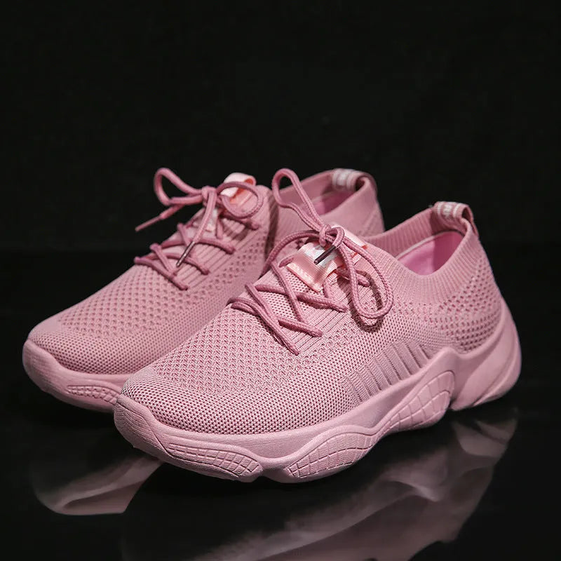 Women's white low-top sports shoes with a woven upper and thick rubber sole.