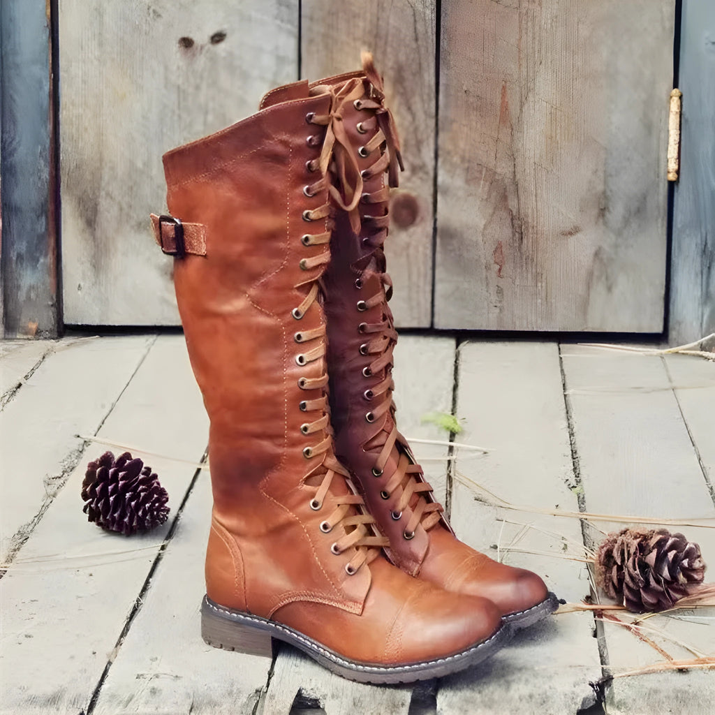 Women's black chunky heel high-leg boots with a round toe and low rubber sole.