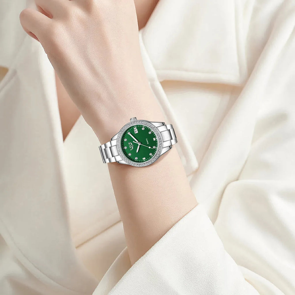 Silver stainless steel ladies watch with diamond-encrusted bezel and round blue dial.