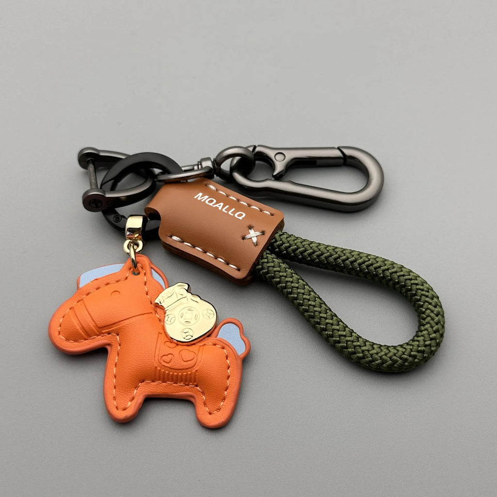 Handmade brown cowhide key ring pendant with a zinc alloy pony buckle on a green flanelle rope.