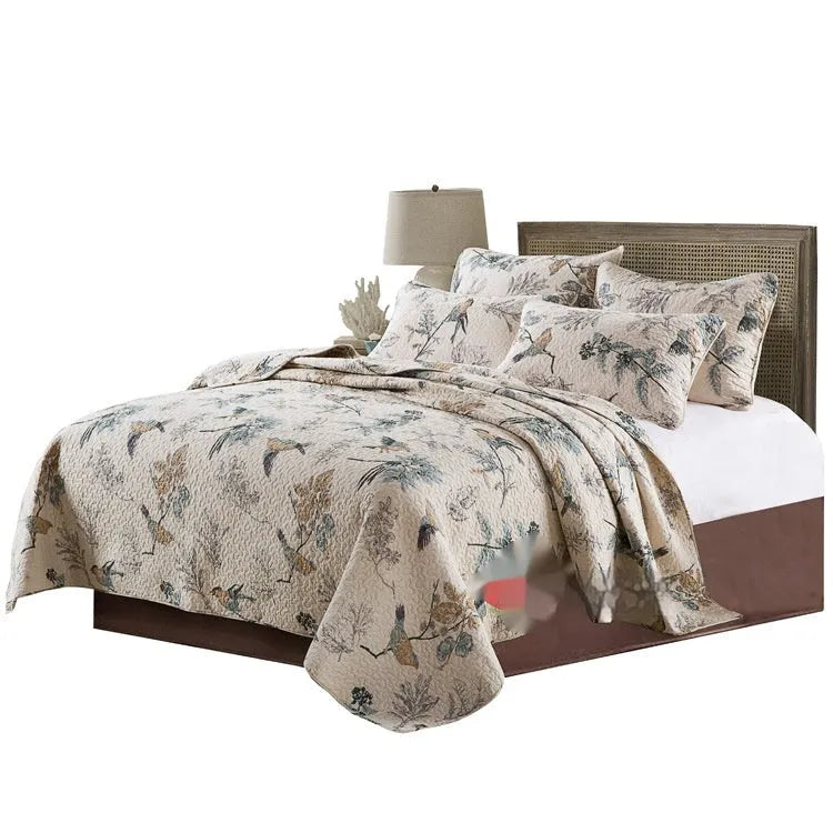 Quilted pure cotton bed cover set with printed pattern, shown with two matching pillowcases on a bed.