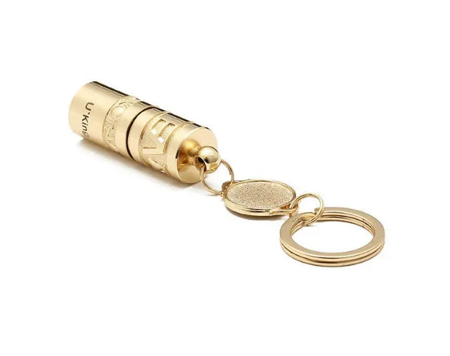 Gold-coloured zinc alloy mini portable LED flashlight on a keyring.