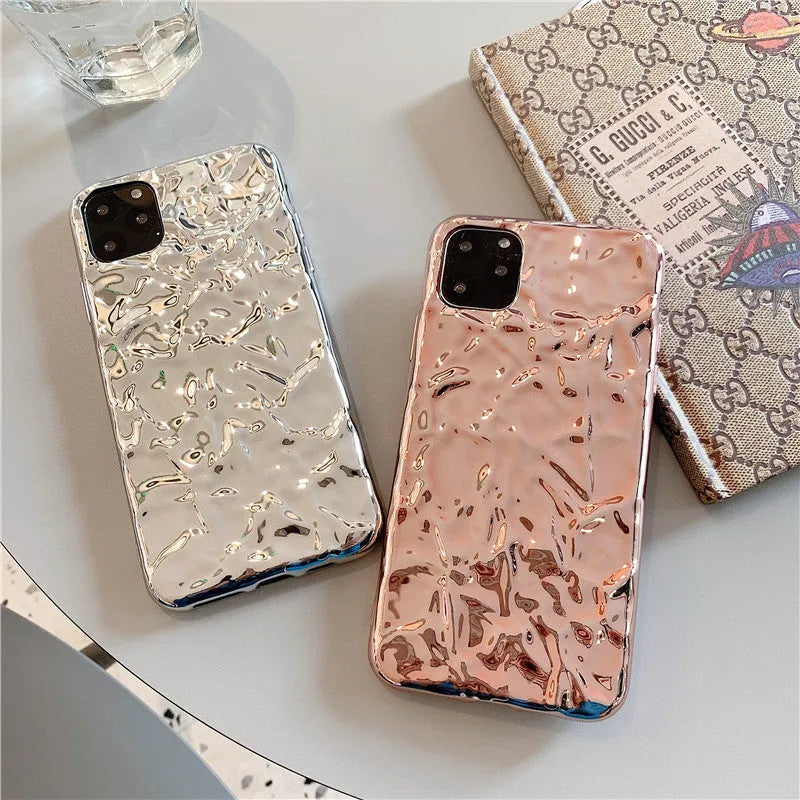 Foldable electroplated TPU iPhone case in rose gold and silver colours, shown on an iPhone.