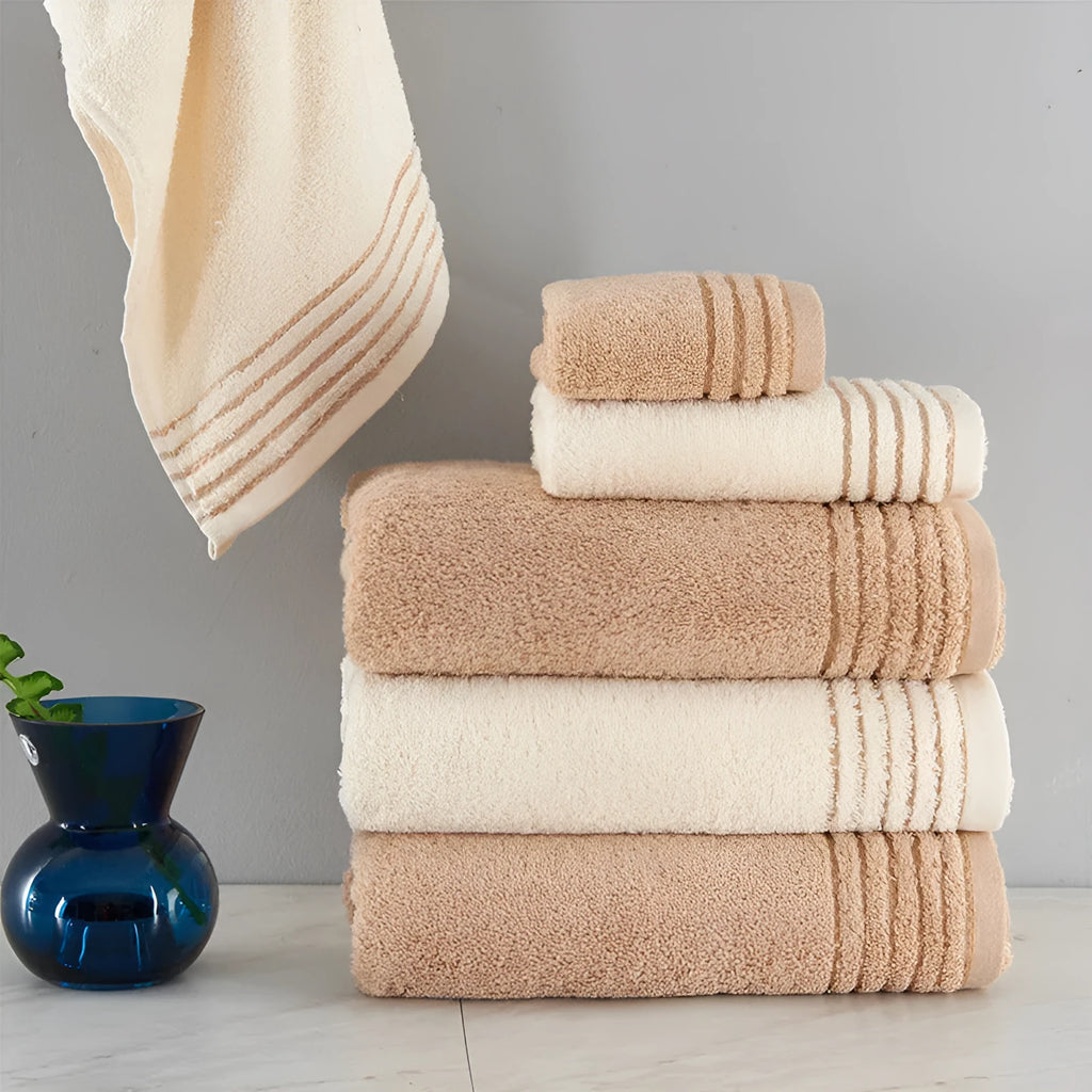 Cotton towel set in beige and brown showing three different sizes including large bath towel