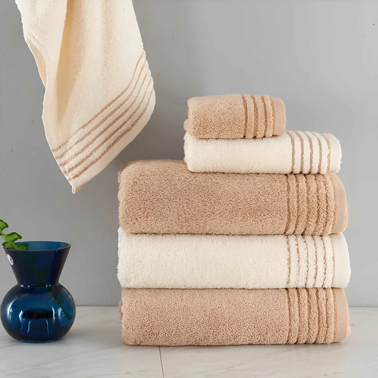 Cotton towel set in beige and brown showing three different sizes including large bath towel
