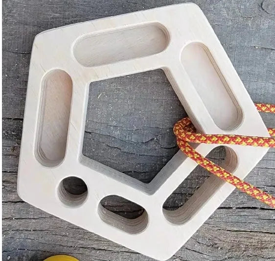 Birch wooden pentagonal-round climbing finger force training plate on a neutral background.