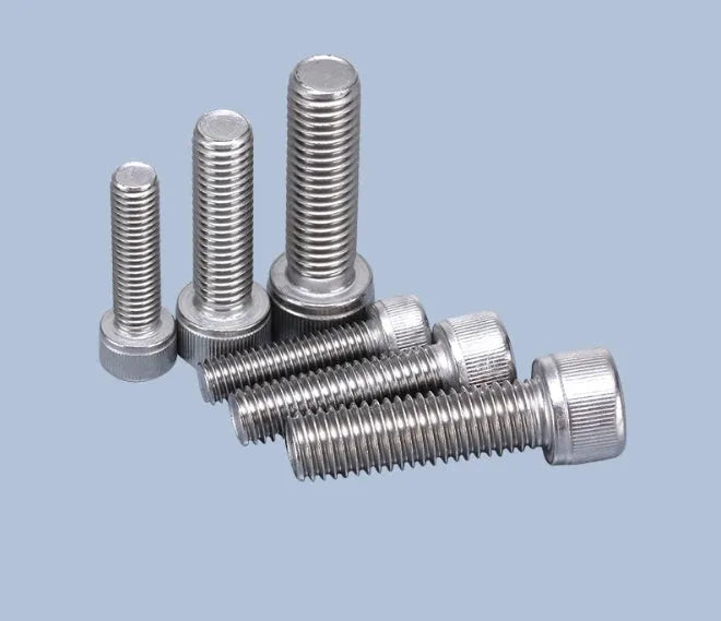 Stainless steel turntable cartridge mounting kit with allen bolts, nuts, washers, and two allen keys on a dark surface.