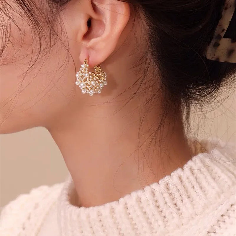 Gold-tone women's earrings with flower basket design and small bead inlay detail