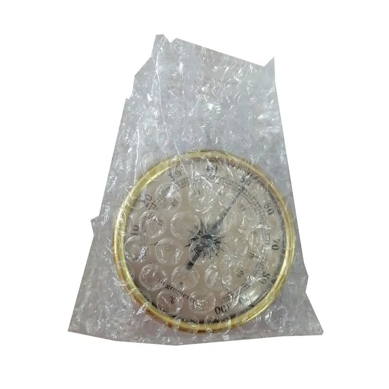 Analogue thermometer and hygrometer with silver aluminium dial and outer ring.