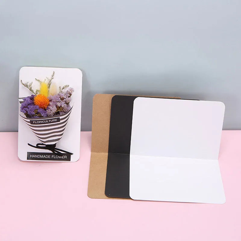 Pack of 100 plain kraft folded greeting cards in black, brown, and white, sized 10 by 15 cm.