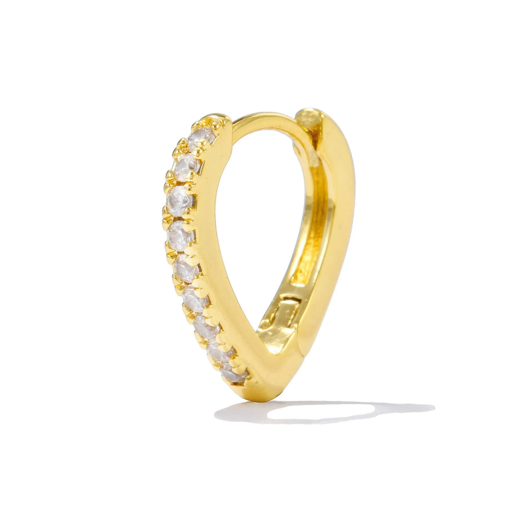 Geometric gold-coloured heart-shaped ear clip on a white background.