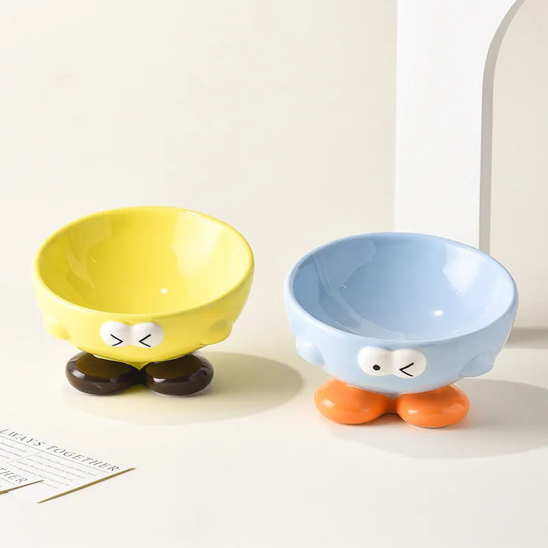 Blue ceramic oblique pet bowl with tall sides and a cute expression print for cervical spine support.