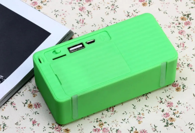 Cannon X3 small cube-shaped portable Bluetooth speaker in various colours on a surface.