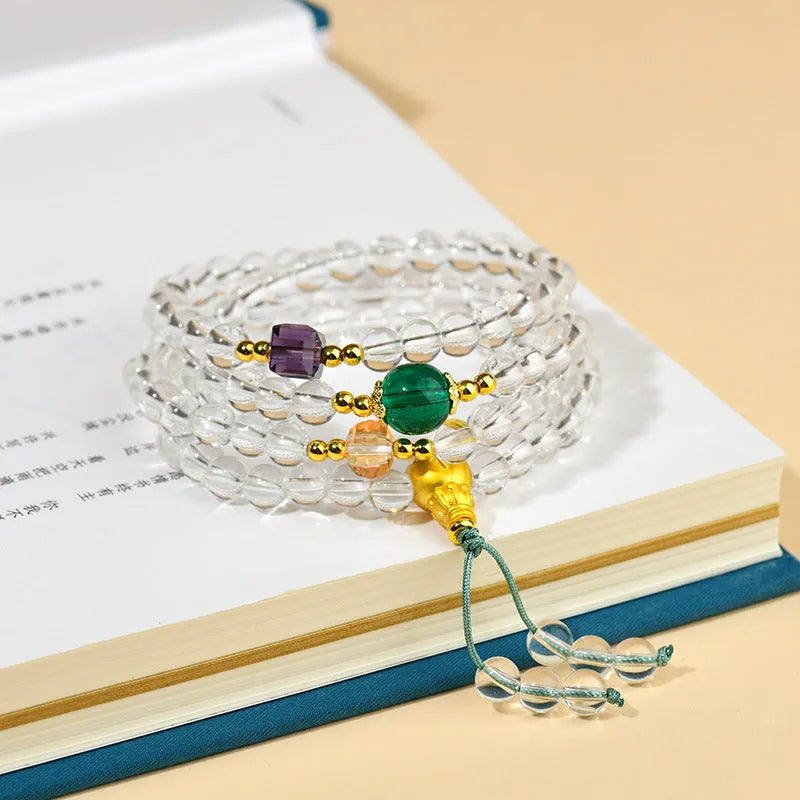 White crystal 108 bead geometric ethnic style bracelet necklace shown worn as both bracelet and necklace