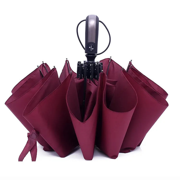 Black triple folding automatic umbrella with steel ribs and a rubber handle, shown open.