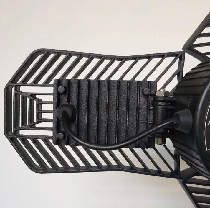A foldable silver aluminium garage work lamp with a clear plastic lens, shown in an open position.