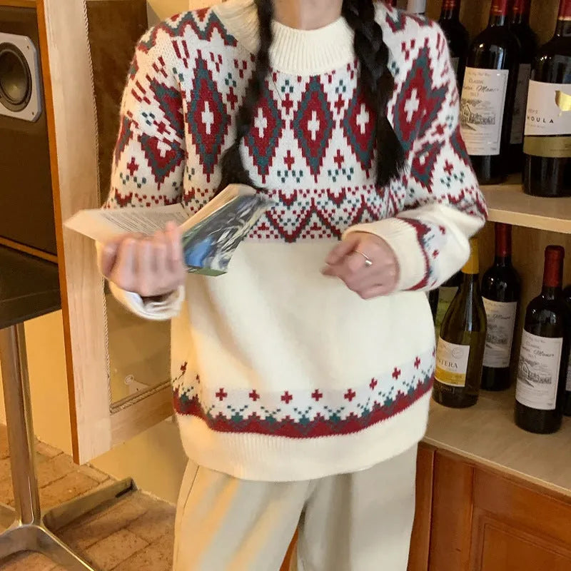 Red and white striped women's loose long-sleeve pullover knitted top on a hanger.