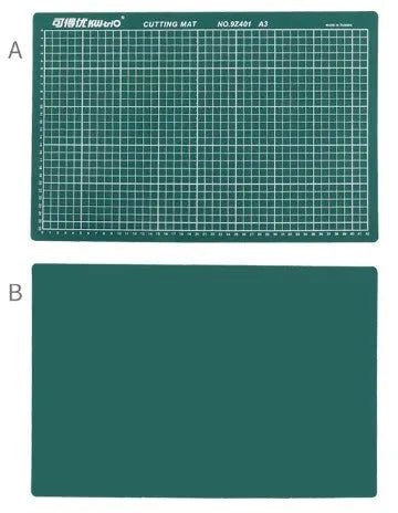 Green A3 self-healing cutting mat with centimetre grid for craft knives on a desk