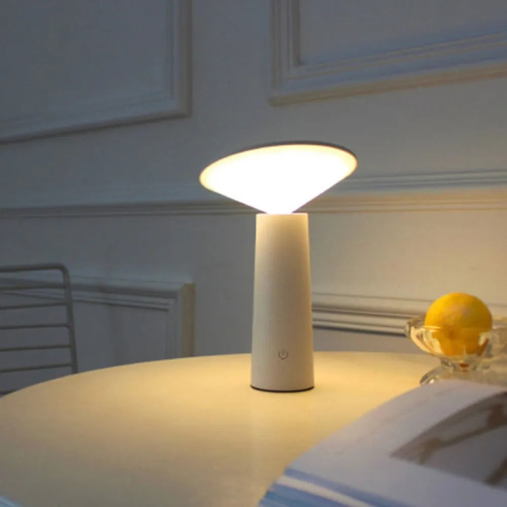 Black USB rechargeable desk lamp with touch sensor, tilted head, and 36 LED light source on a wooden table.