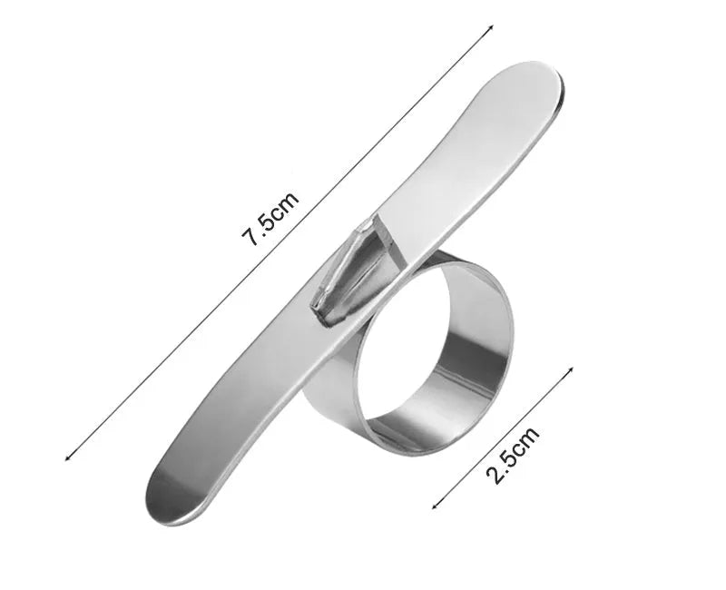 Silver stainless steel fruit peeler ring for oranges, citrus, and pomegranates on a kitchen surface.
