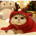 Red polar fleece dog cloak with antlers on the hood for a small dog in winter.