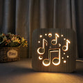 Square pine wood frame USB LED atmosphere lamp emitting warm white light on a desk.