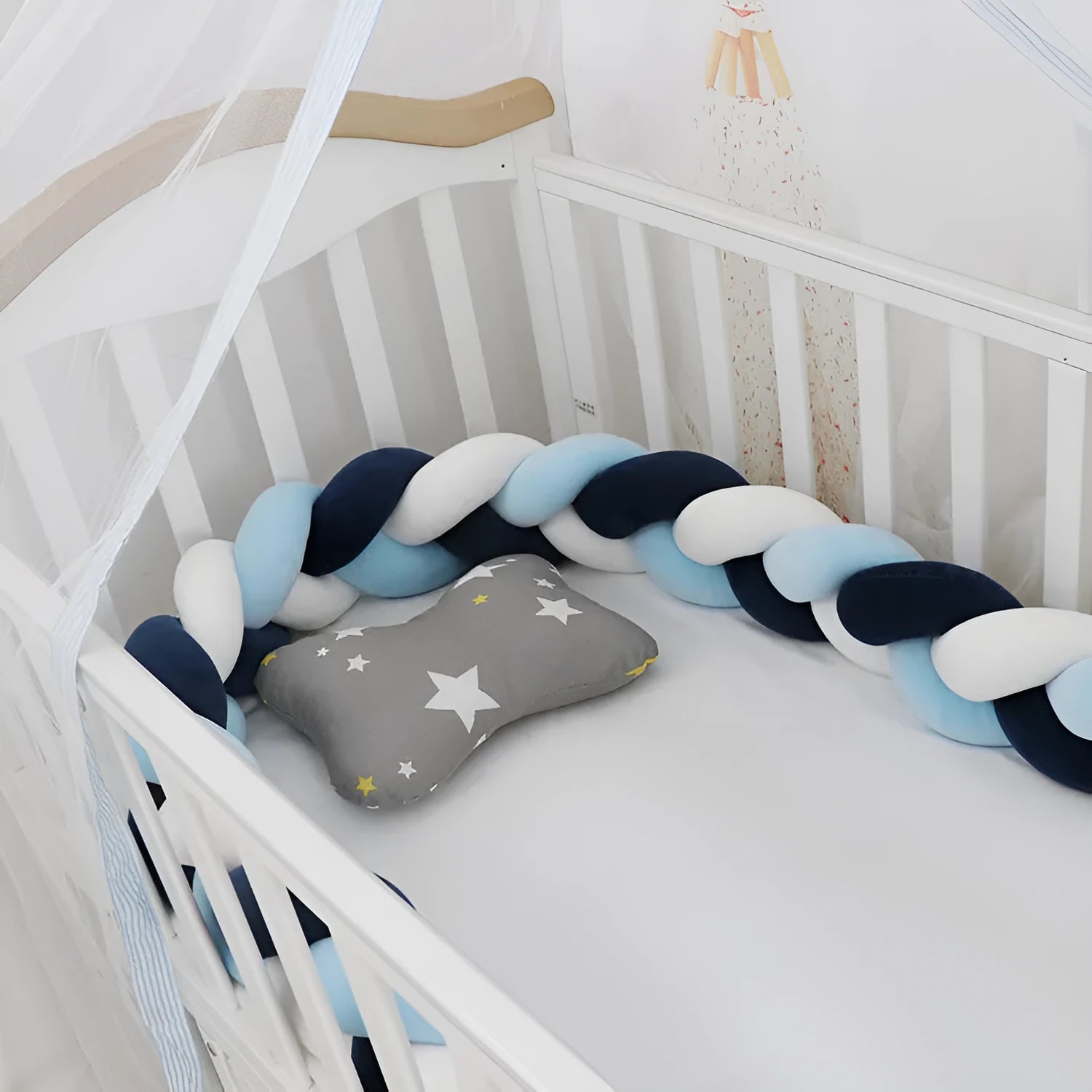 Bendable braid knot baby crib bumper in spandex velvet fabric on a white cot.