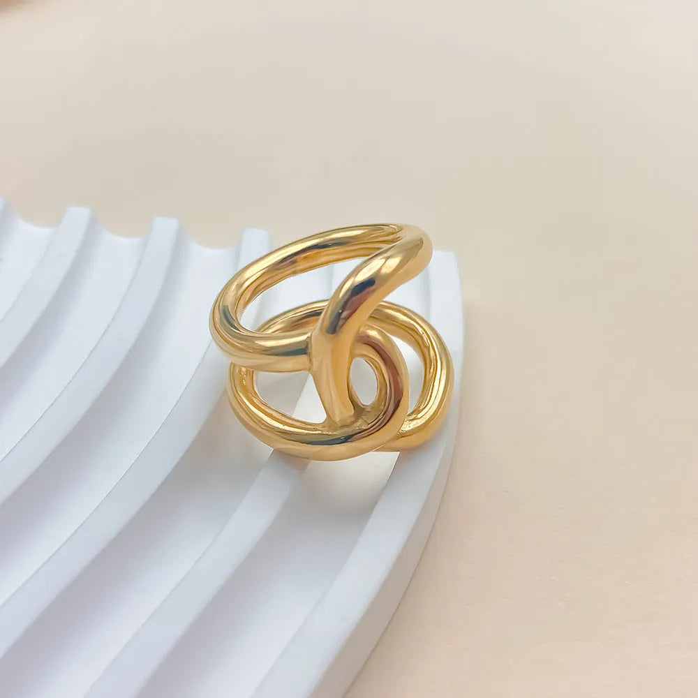 Adjustable knotted stainless steel ring for women in gold or steel colour, showing U-shaped geometric design.