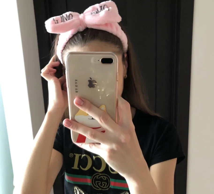 Coral velvet butterfly end hair band with letter text design in pink colour on neutral background