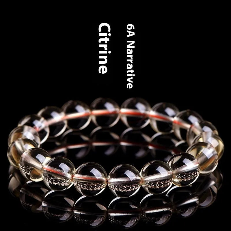 Handmade natural citrine scattered beads ball bracelet on a wrist, showing polished yellow gemstones.