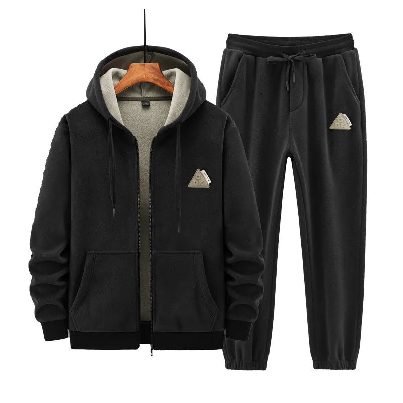 Grey hooded sweater and matching cotton trousers casual sport suit laid flat