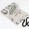 Black Peony printed canvas pencil roll bag open to show 72 holes for pens and pencils
