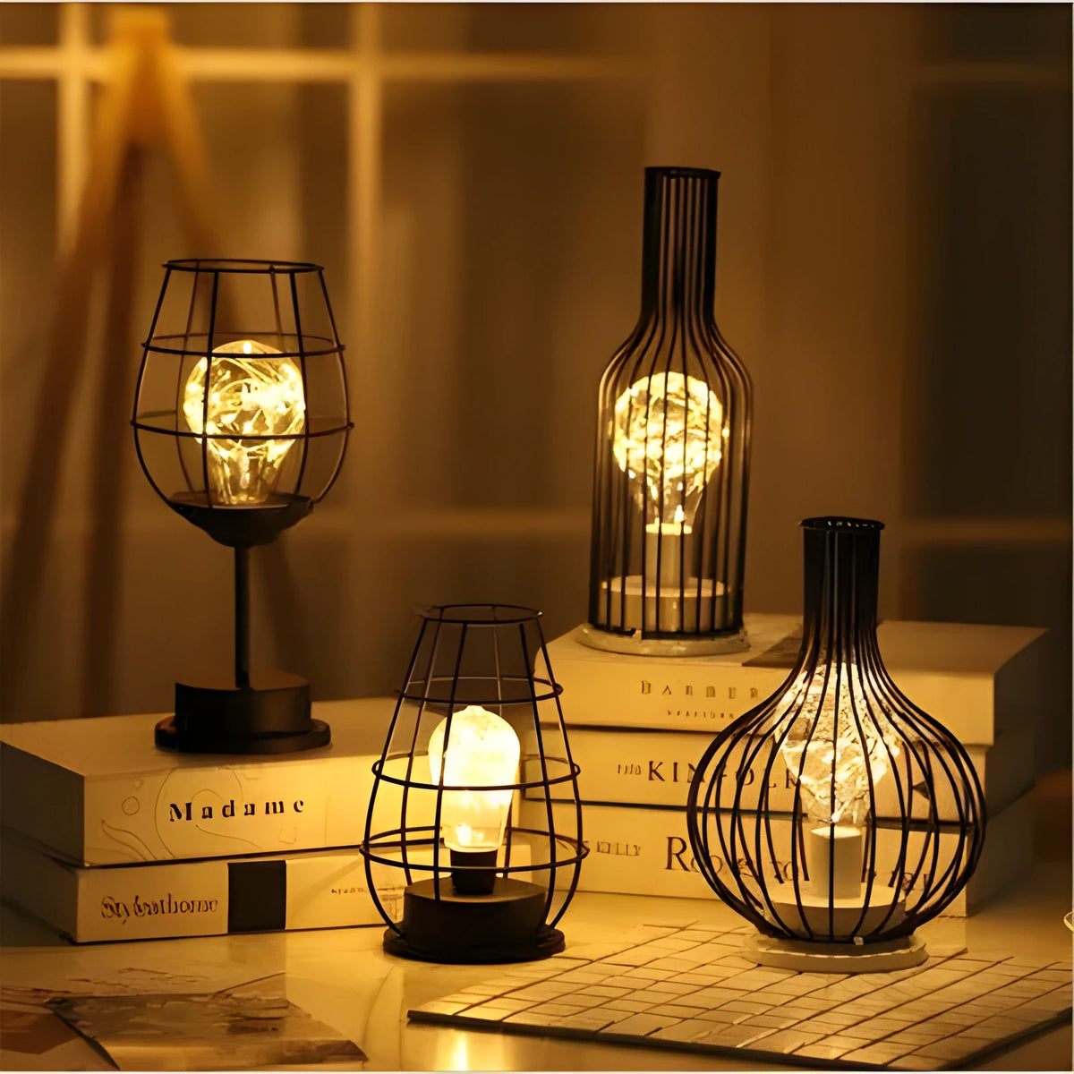 Minimalist hollow wrought iron table lamp in red wine bottle shape with warm white light on a desk