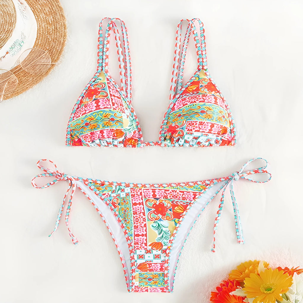 Women's lace-up split swimsuit in picture colour, showing backless design and adjustable ties.