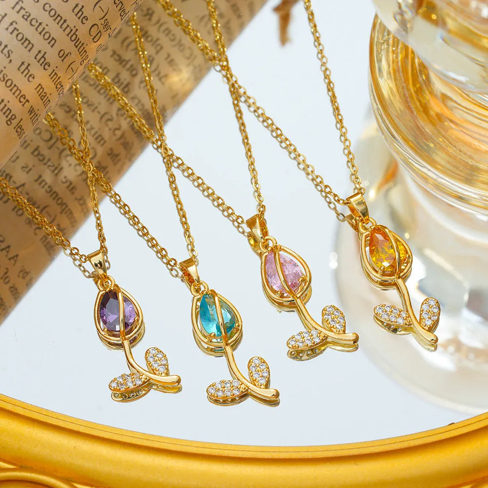 Zircon tulip flower pendant necklace on an adjustable titanium steel chain, shown in a gold colour.